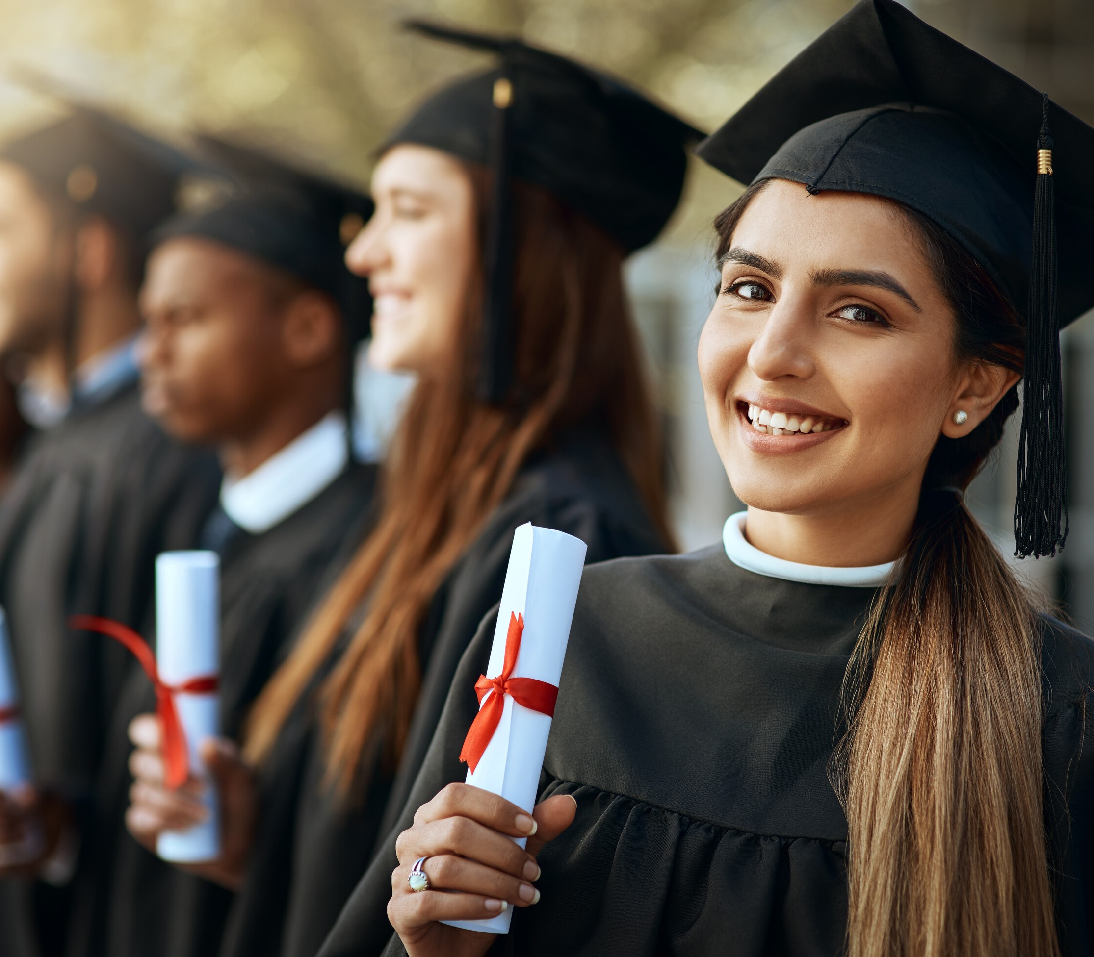 Young people in graduation caps