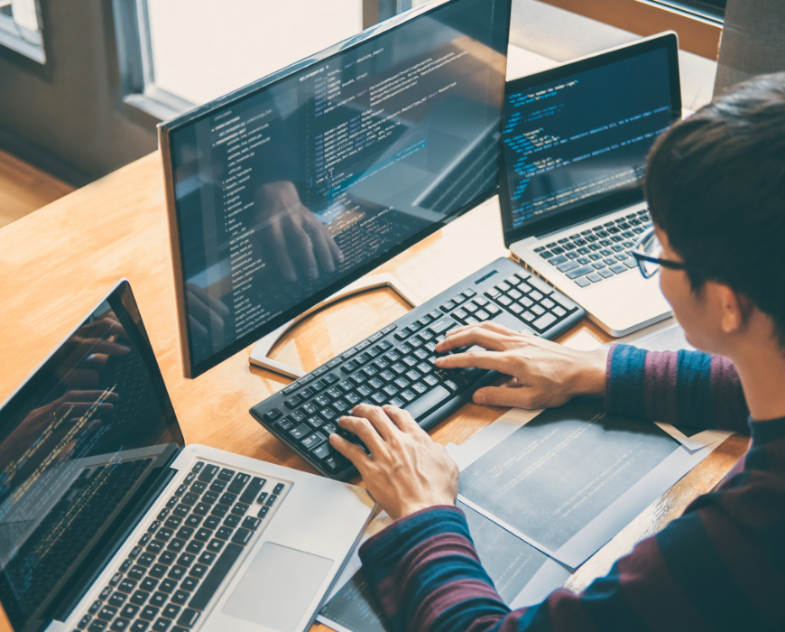man coding at desk