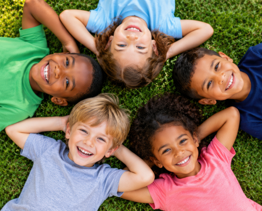 smiling children laying on grass